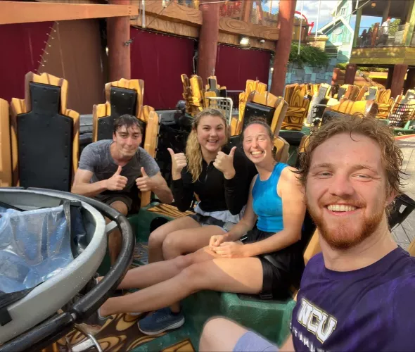 a group of four people on an amusement park ride